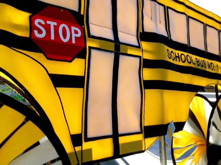 large yellow school bus garden spinner by bald eagle flag store fredericksburg va, large bus spinner rotates and wheels spin in the wind